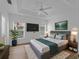 Serene main bedroom with a tray ceiling, light wood floors, and large windows at 2204 L Pavia Blvd # 2204, Venice, FL 34292