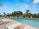 Inviting community pool with plenty of lounge chairs and landscaping at 2204 L Pavia Blvd # 2204, Venice, FL 34292