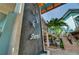 Exterior of Sharky's Restaurant with a waterfall feature, palm trees, and outdoor seating at 2204 L Pavia Blvd # 2204, Venice, FL 34292