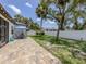 Well-maintained backyard with a patio, lush green grass, and a white fence for privacy at 2245 Pickard Ln, North Port, FL 34286