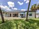 Expansive backyard featuring a patio area, green lawn, and mature trees for shade and privacy at 2245 Pickard Ln, North Port, FL 34286