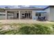 Wide backyard view of a covered patio and seating area with an open backyard at 2245 Pickard Ln, North Port, FL 34286