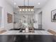 Dining room showcasing a stylish table and chairs, modern lighting, and an open view to the living area and kitchen at 2245 Pickard Ln, North Port, FL 34286