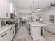 Open-concept kitchen featuring sleek countertops, stainless steel appliances, modern cabinetry, and an island at 2245 Pickard Ln, North Port, FL 34286