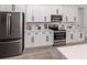 Contemporary kitchen featuring white cabinets, stainless steel appliances, and ample counter space at 2245 Pickard Ln, North Port, FL 34286