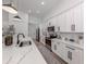 Contemporary kitchen featuring white cabinetry, stainless steel appliances, a large countertop, and ample natural light at 2245 Pickard Ln, North Port, FL 34286