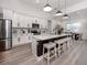 Modern kitchen with a large center island, stainless steel appliances, ample cabinetry, and views of the dining area at 2245 Pickard Ln, North Port, FL 34286