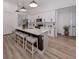 Modern kitchen featuring white cabinets, a spacious island with seating, and stainless steel appliances at 2245 Pickard Ln, North Port, FL 34286