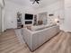 Well-lit living room featuring a large sectional sofa, modern entertainment center, and stylish decor at 2245 Pickard Ln, North Port, FL 34286