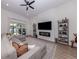 Bright and airy living room with a comfortable sectional sofa, modern fireplace, and stylish decor at 2245 Pickard Ln, North Port, FL 34286