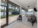 Relaxing covered patio featuring an open-air design with multiple seating areas and a backyard view at 2245 Pickard Ln, North Port, FL 34286
