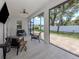Relaxing covered patio featuring an open-air design with multiple seating areas and a backyard view at 2245 Pickard Ln, North Port, FL 34286