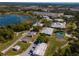 Aerial view of campus buildings surrounded by trees and a lake at 2355 Allsup Ter, North Port, FL 34286