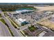 Areal image of commercial development with large retail buildings, parking areas, and access roads at 2355 Allsup Ter, North Port, FL 34286