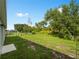 Large, private backyard with lush greenery, defined fencing, and ample space for recreation at 2355 Allsup Ter, North Port, FL 34286