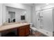 Bright bathroom featuring a single sink vanity and a walk-in shower at 2355 Allsup Ter, North Port, FL 34286