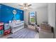 Bright Bedroom with a modern baby crib and decor at 2355 Allsup Ter, North Port, FL 34286