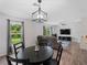 Open-concept dining area with modern lighting, views to the yard, and wood-look flooring at 2355 Allsup Ter, North Port, FL 34286