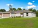 Charming single-story home with a well-manicured lawn and attached two-car garage on a sunny day at 2355 Allsup Ter, North Port, FL 34286