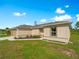 Tan single-story home featuring a well-manicured lawn and neutral-colored trim on a sunny day at 2355 Allsup Ter, North Port, FL 34286