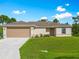 Tan home with an attached garage, front yard, and a neatly maintained lawn with landscaping at 2355 Allsup Ter, North Port, FL 34286
