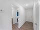 Hallway with wood-look flooring offering access to the bathroom, bedrooms, and main entrance at 2355 Allsup Ter, North Port, FL 34286