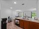 Open kitchen layout flowing to dining/living area, showcasing the breakfast bar and modern appliances at 2355 Allsup Ter, North Port, FL 34286