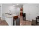 Functional kitchen with a breakfast bar, wood-look flooring, and sleek stainless steel appliances at 2355 Allsup Ter, North Port, FL 34286