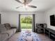 Cozy living room with sliding glass doors leading to the backyard, modern furnishings, and a ceiling fan at 2355 Allsup Ter, North Port, FL 34286