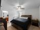 This is a spacious main bedroom with wood-look flooring and a ceiling fan at 2355 Allsup Ter, North Port, FL 34286
