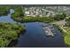 Aerial view of a waterfront community featuring private boat docks, water access, and lush landscaping at 239 Cutter Ct, North Port, FL 34287