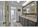 Bathroom featuring double sinks and an oversized mirror over the vanity at 239 Cutter Ct, North Port, FL 34287