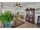 Cozy living room with wood-look floors, a ceiling fan, and comfortable seating arrangements at 239 Cutter Ct, North Port, FL 34287
