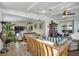Open-concept living room with wood-look tile flooring, comfortable seating, and bright, natural light at 239 Cutter Ct, North Port, FL 34287