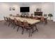 A spacious meeting room features large tables, chairs, and TV screen at 239 Cutter Ct, North Port, FL 34287