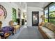 A well lit sunroom with vintage wicker furniture and striped couch at 239 Cutter Ct, North Port, FL 34287