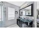 Modern bathroom with dual sinks, and an updated glass enclosed shower at 2445 Apache St, Sarasota, FL 34231