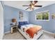 Bright bedroom features a ceiling fan, window overlooking the yard, and side table with lamp at 2445 Apache St, Sarasota, FL 34231