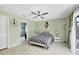 Cozy bedroom with en-suite bathroom, ceiling fan, and light green walls at 2445 Apache St, Sarasota, FL 34231
