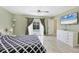 Spacious bedroom with en-suite bathroom, ceiling fan, and a view of the pool area at 2445 Apache St, Sarasota, FL 34231