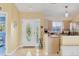Bright foyer with tile flooring, a decorative glass front door, and views into the kitchen and dining area at 2445 Apache St, Sarasota, FL 34231
