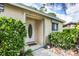 Inviting front entryway featuring a decorative oval glass door, a small welcome mat, and lush greenery at 2445 Apache St, Sarasota, FL 34231