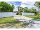 Charming one-story home with a long gravel driveway leading up to the residence, surrounded by lush greenery at 2445 Apache St, Sarasota, FL 34231