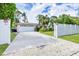 Charming single-story home with a well-manicured lawn and a concrete driveway leading to a two-car garage at 2445 Apache St, Sarasota, FL 34231
