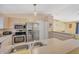Bright kitchen area with stainless steel appliances, double sink, and ample counter space at 2445 Apache St, Sarasota, FL 34231