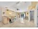 Bright, open living room with tile flooring and a view of the screened-in pool area at 2445 Apache St, Sarasota, FL 34231