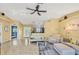 Inviting living room with tile floors, a ceiling fan, and an open view of the kitchen area at 2445 Apache St, Sarasota, FL 34231