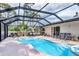 Gorgeous pool with screened-in lanai, ample seating, and a spa for ultimate outdoor relaxation and entertainment at 2445 Apache St, Sarasota, FL 34231
