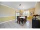 Charming dining room with tile floors, natural light, and access to the backyard at 24536 Buckingham Way, Port Charlotte, FL 33980