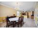 Open-concept dining room with views of the kitchen, tile flooring, and a chandelier at 24536 Buckingham Way, Port Charlotte, FL 33980